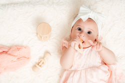 Baby holding a Wooden Montessori 4-piece toy set