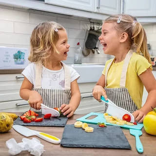 Kids cutting fruits with a Montessori Kitchen Kit.