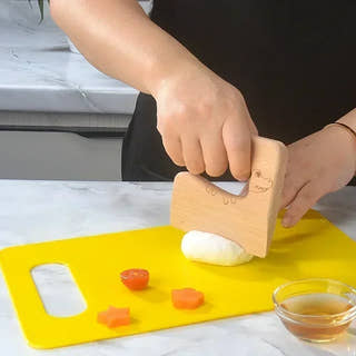 Child cutting dough with Montessori Kitchen Kit